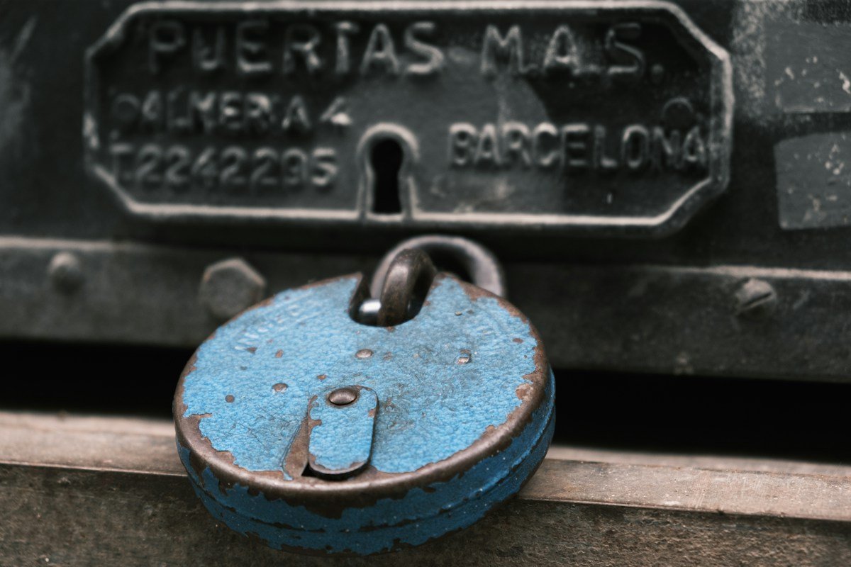 Weathered padlock on a metal door
